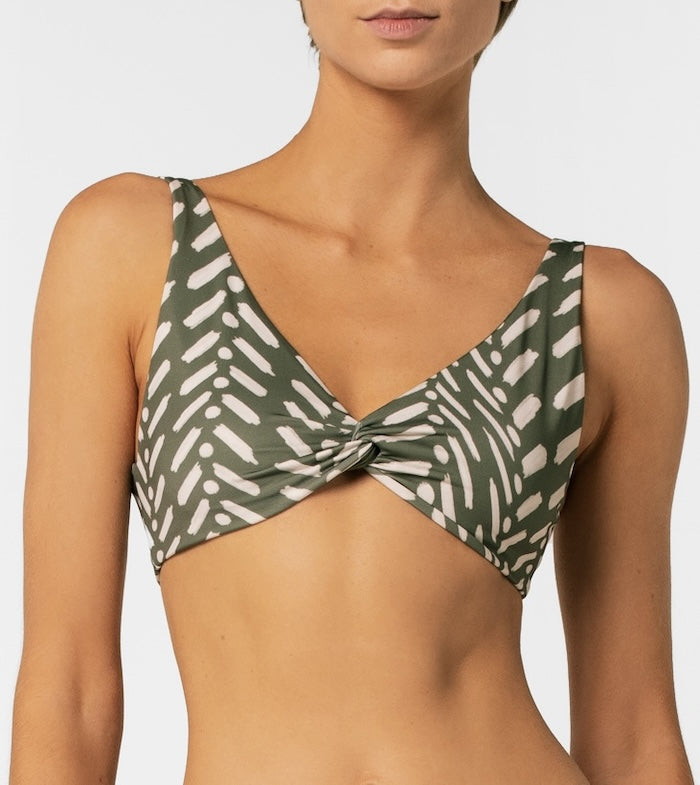 Green and white patterned bikini top on a plain background.