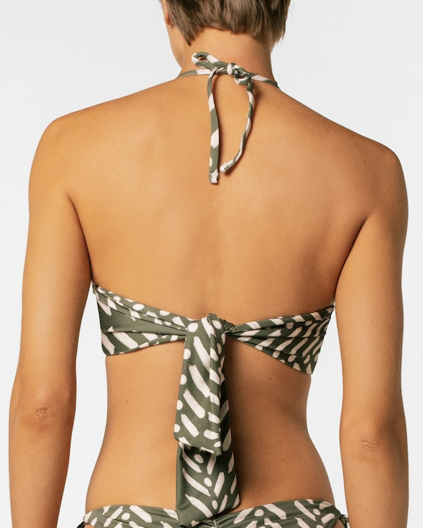 Green and white patterned bikini top on a plain background.