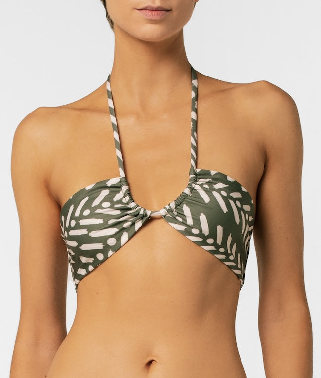 Green and white patterned bikini top on a plain background.