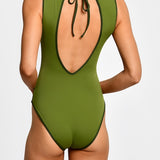 Green one-piece swimsuit with open back on a white background.