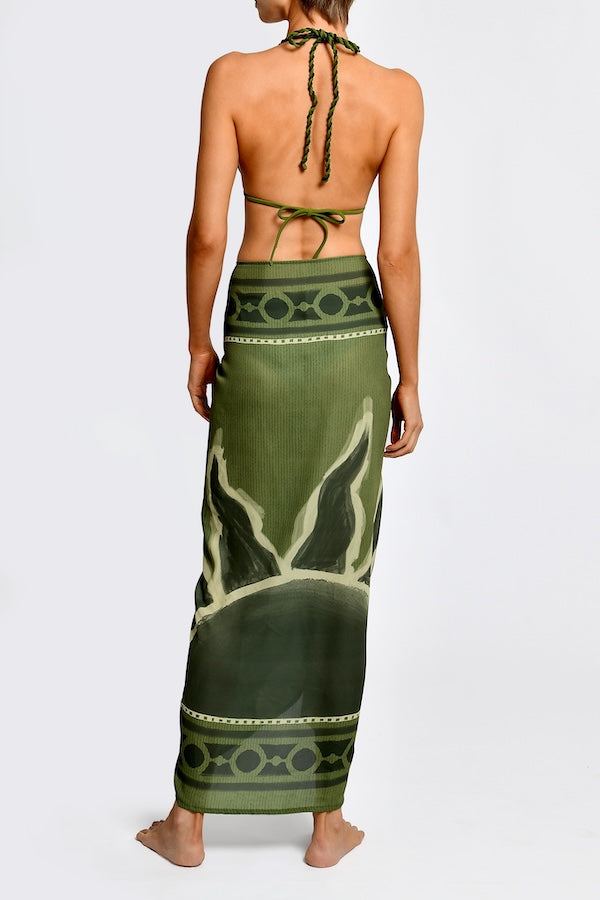 Women wearing green patterned bikini with matching sarong set on a white background.