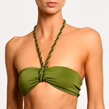 Green halter style bikini top with braided straps on a plain background.