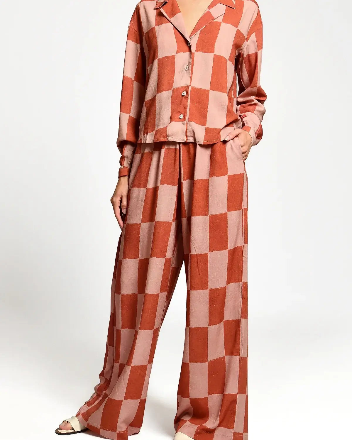 Checkered outfit with a shirt and pants on a white background.