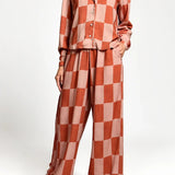 Checkered outfit with a shirt and pants on a white background.