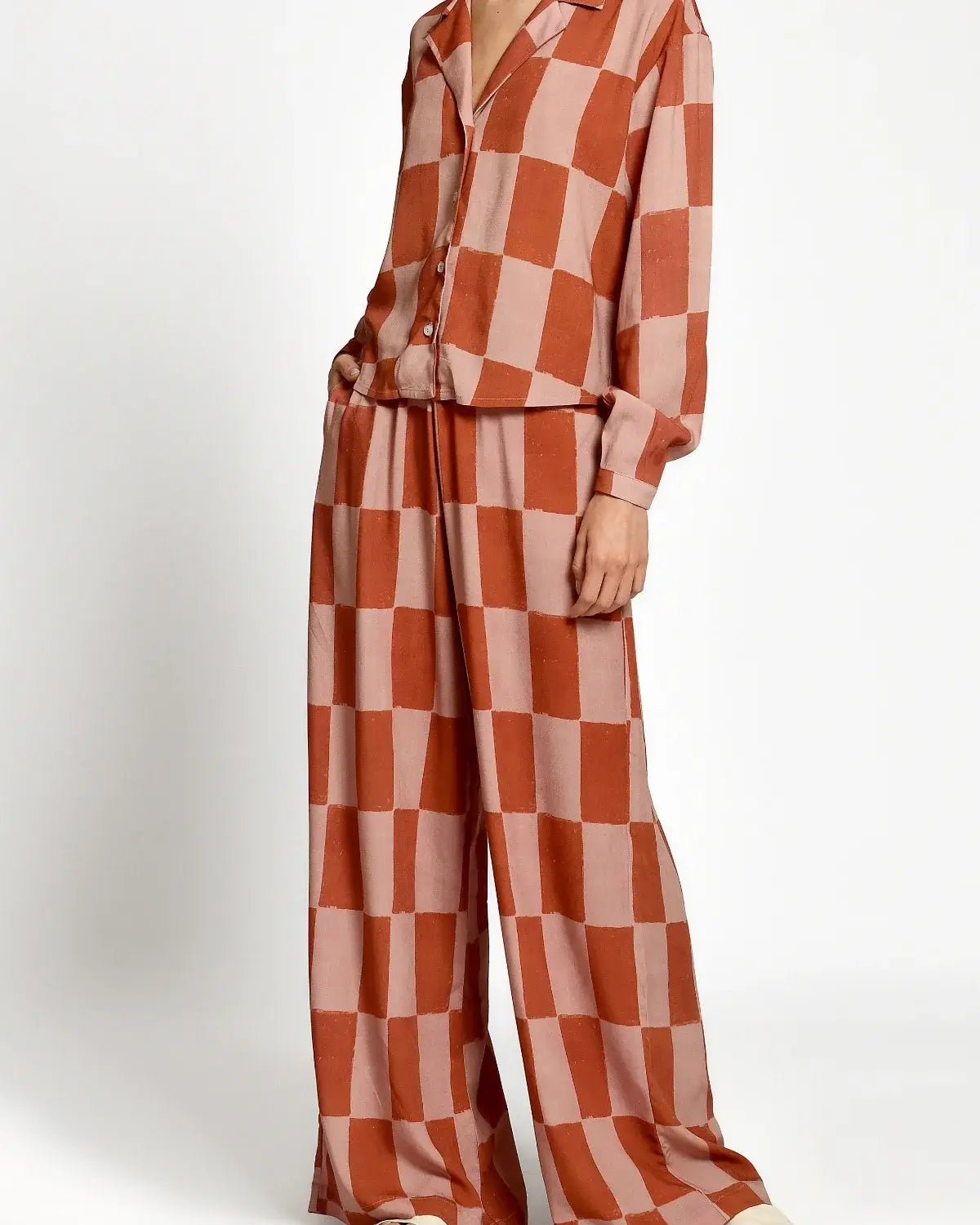 Checkered outfit with a shirt and wide-leg pants on a white background.