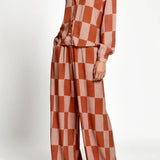 Checkered outfit with a shirt and wide-leg pants on a white background.
