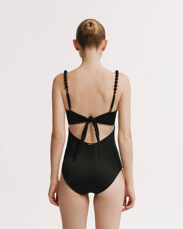 Black swimsuit with open back design on a white background
