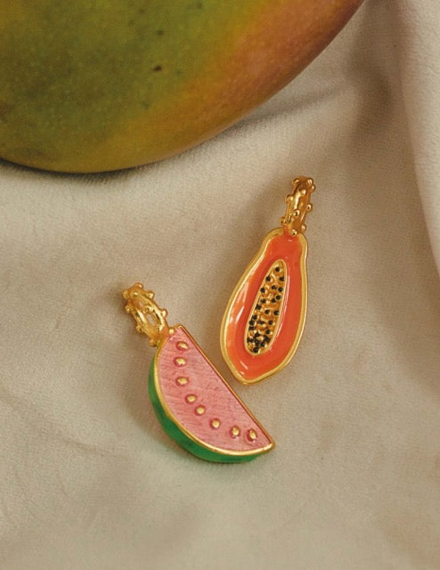 A close-up of gold plated papaya and watermelon charms.