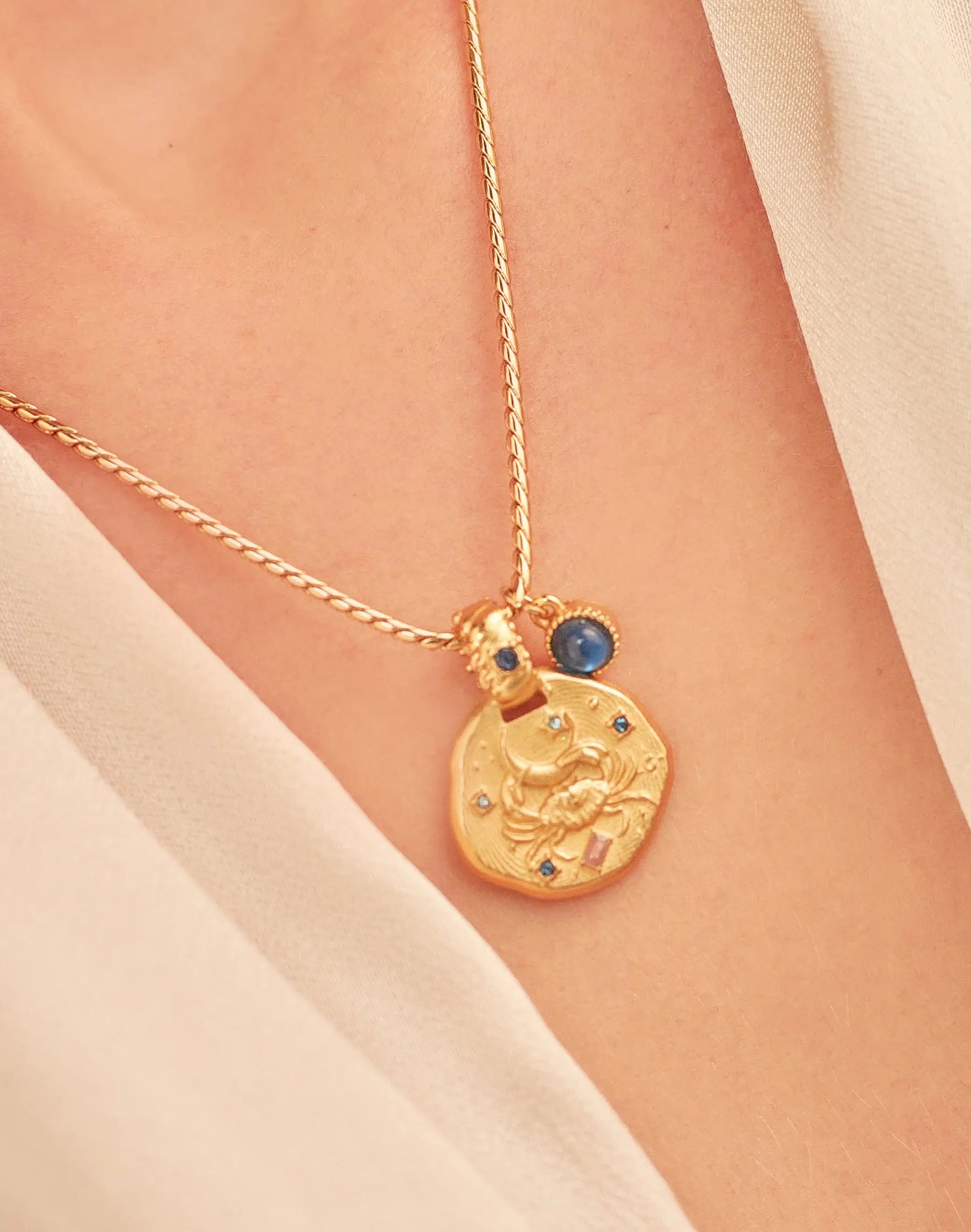 A 24k gold-plated necklace for Cancer  zodiac pendant, accompanied by a natural stone charm.
