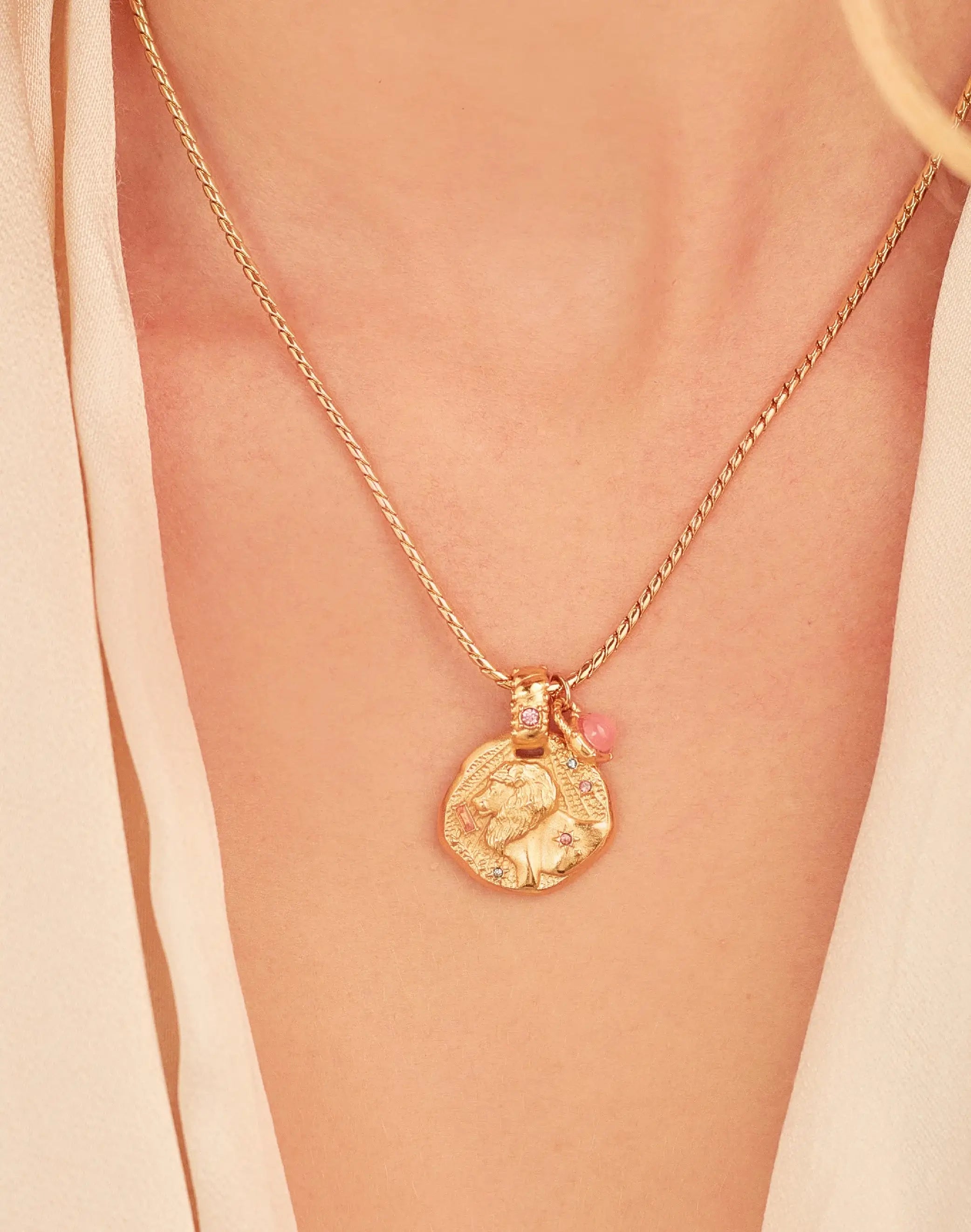 A 24k gold-plated necklace for Leo zodiac pendant, accompanied by a natural stone charm.