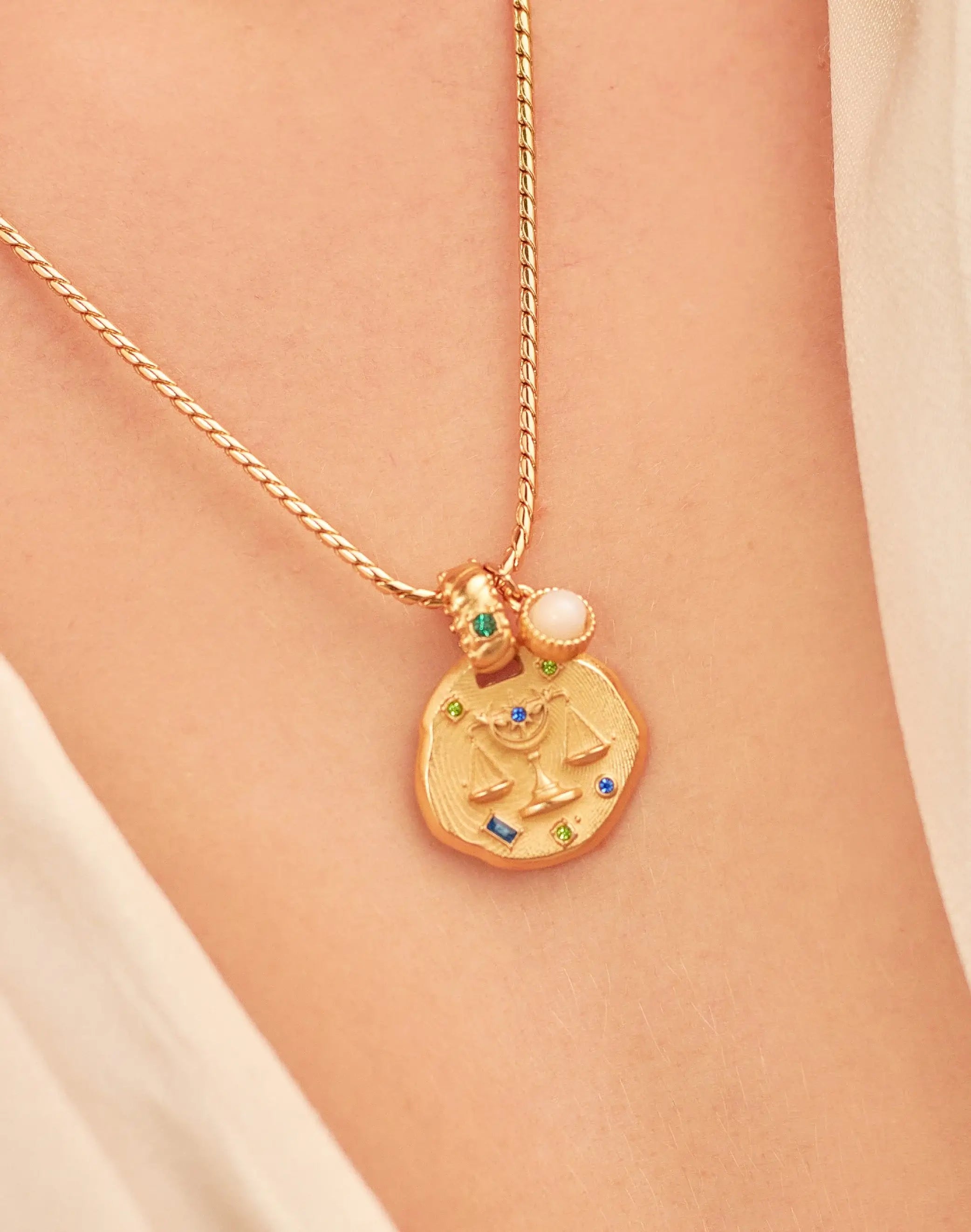 A 24k gold-plated necklace for Libra  zodiac pendant, accompanied by a natural stone charm.