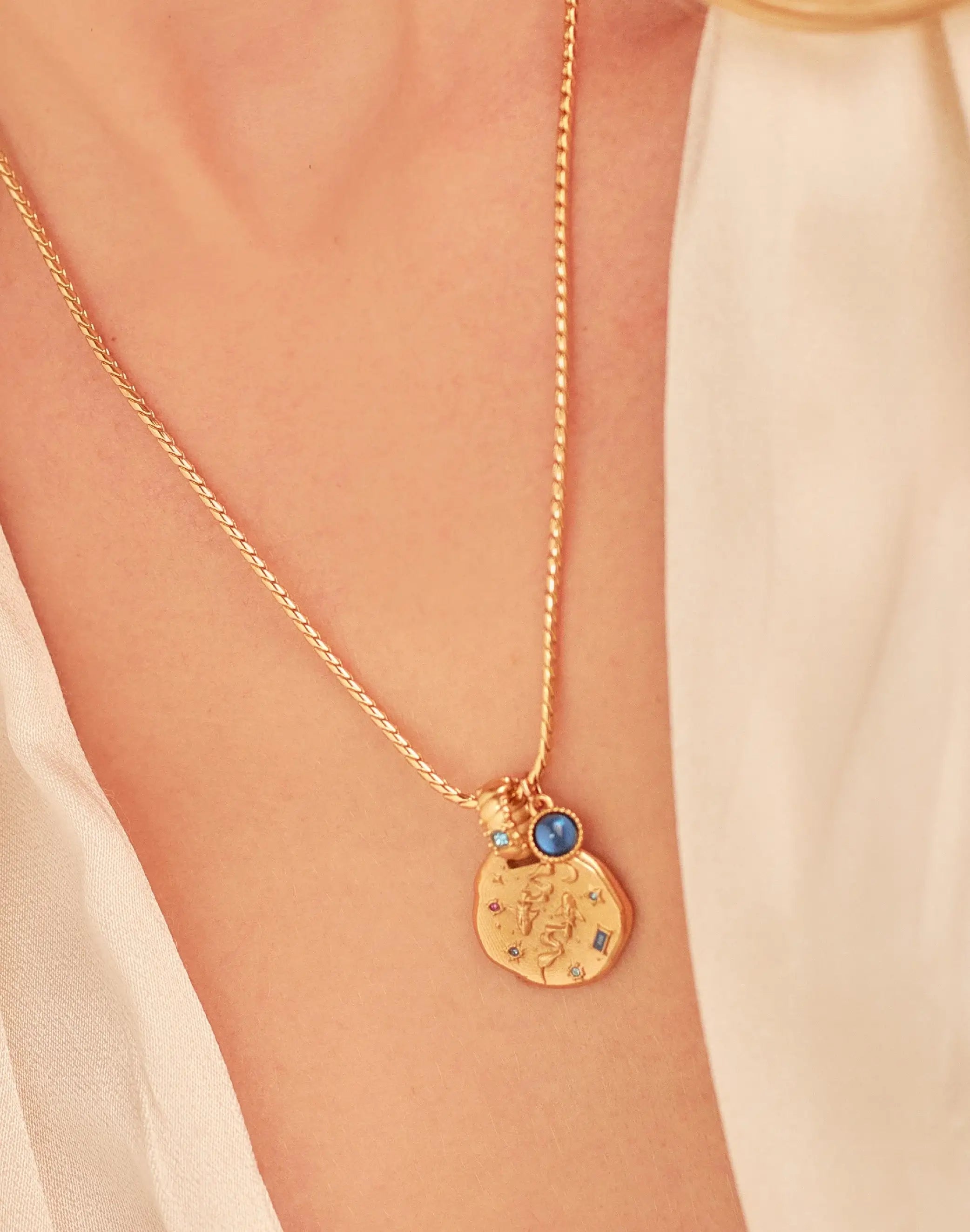 A 24k gold-plated necklace for Pisces  zodiac pendant, accompanied by a natural stone charm.