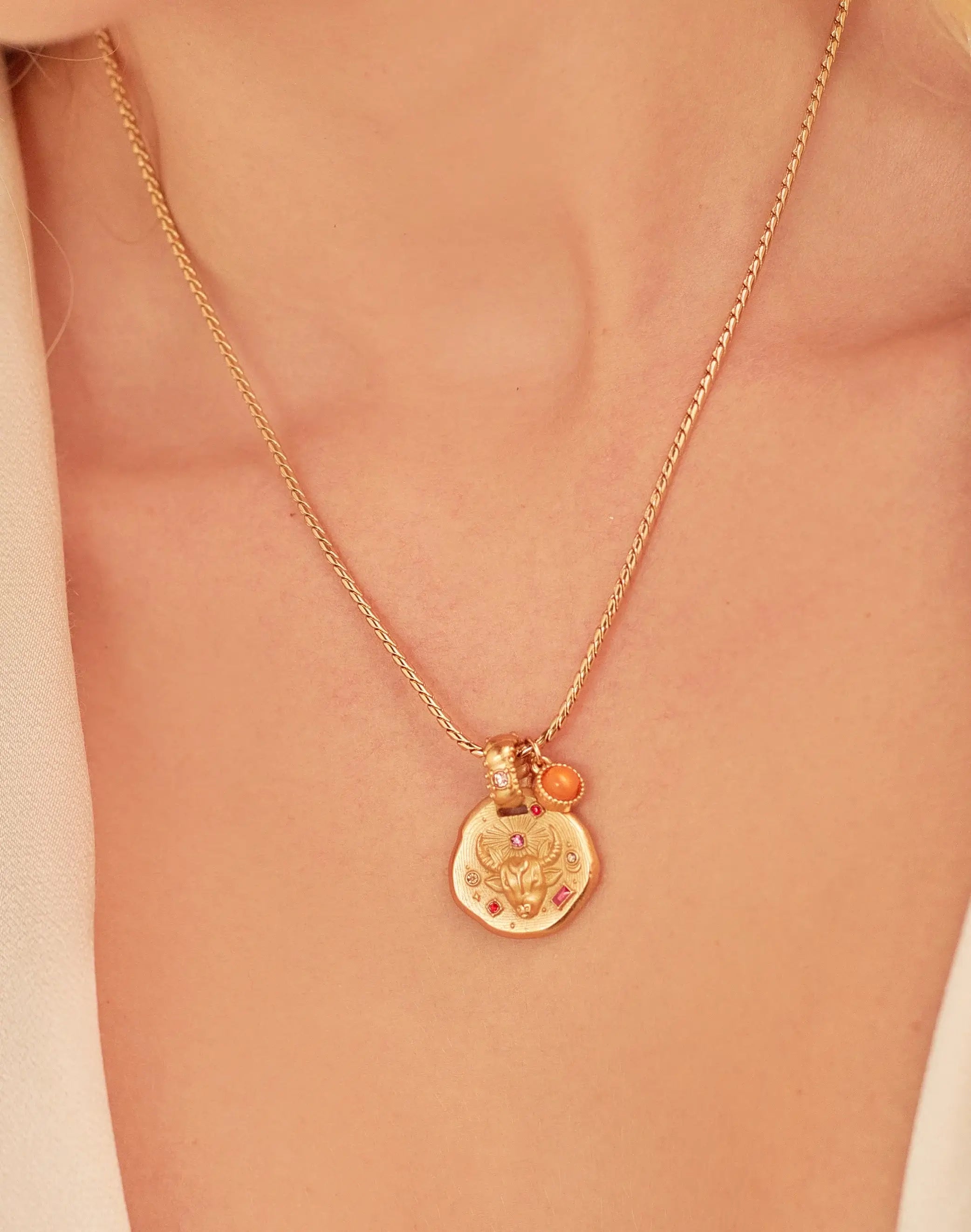 A 24k gold-plated necklace for Tauro  zodiac pendant, accompanied by a natural stone charm.
