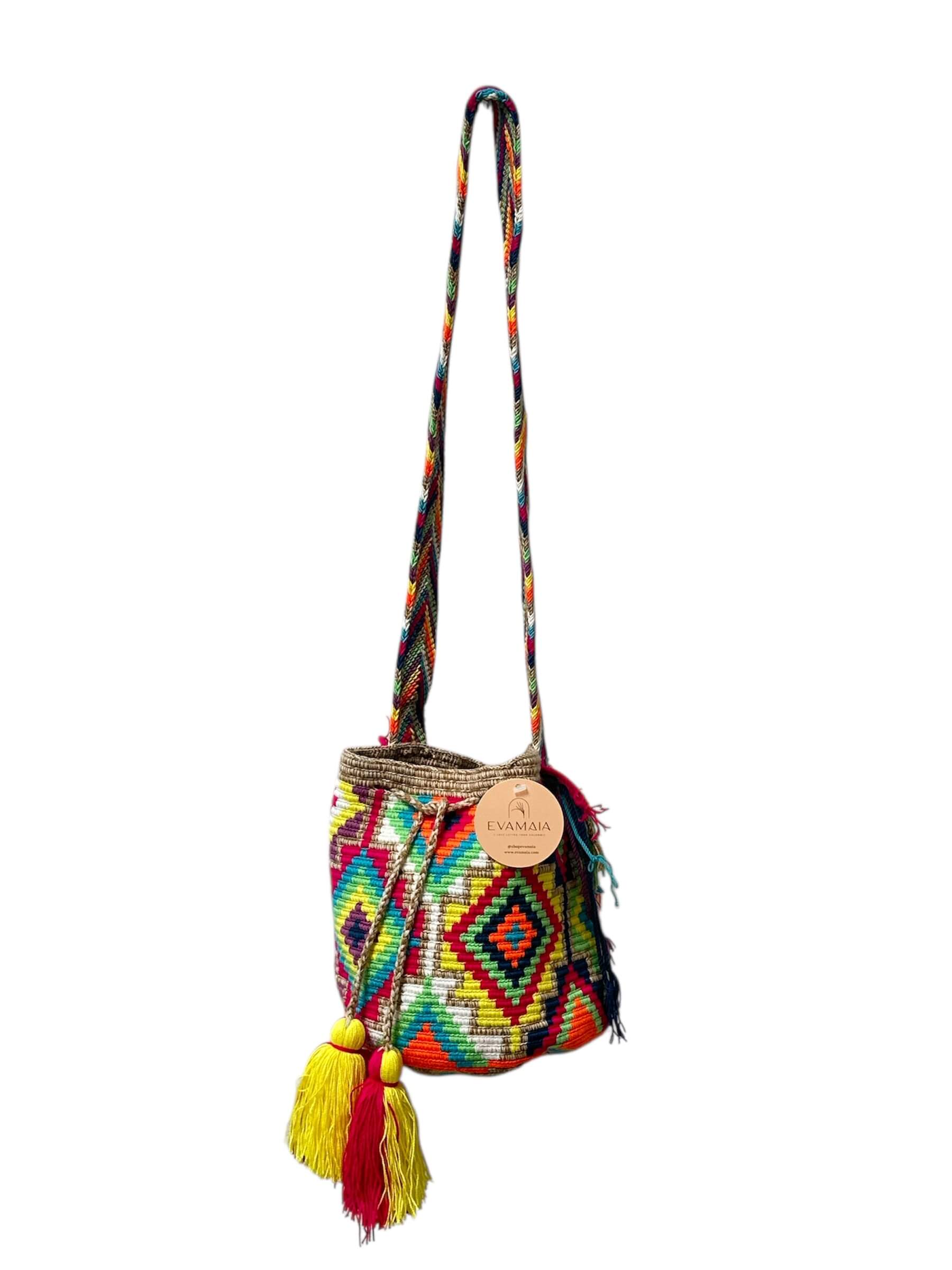 Colorful handbag with geometric pattern and tassels on a white background.