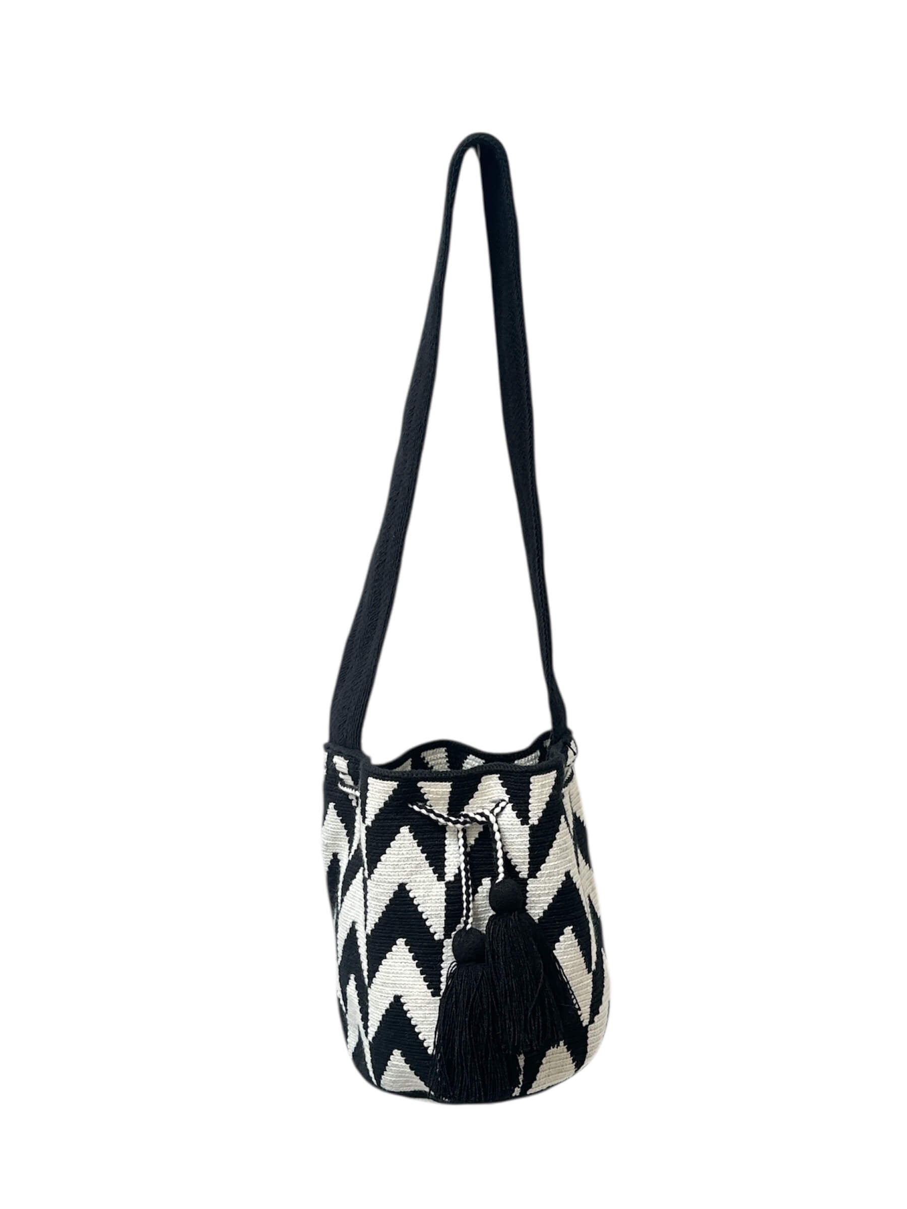 Black and white zigzag patterned bag with a strap on a white background.