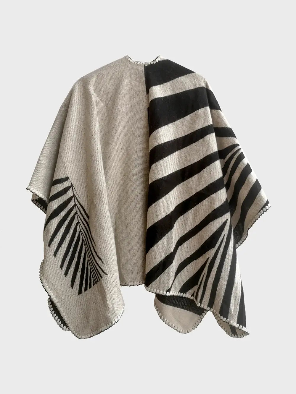 A black and white poncho inspired by geometric shapes.