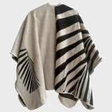A black and white poncho inspired by geometric shapes.