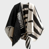 A black and white geometric inspired poncho.