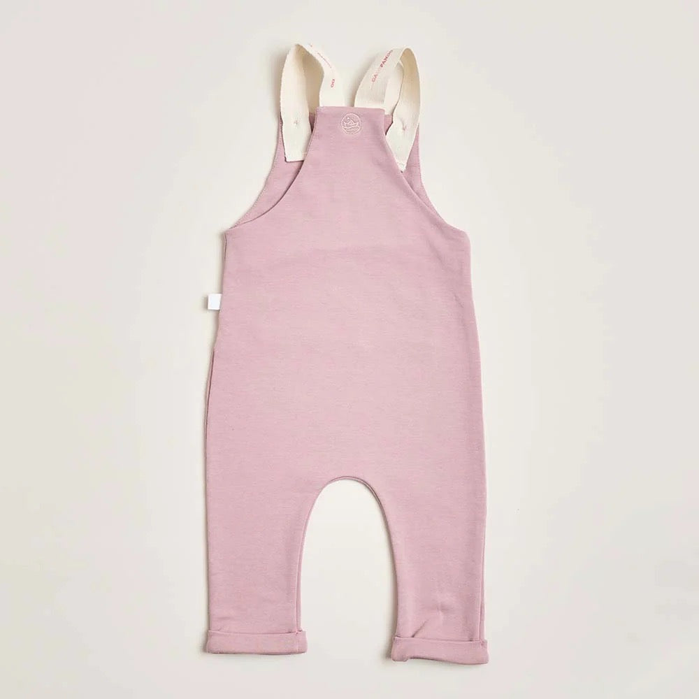 The back of a pink seahorse overall with front pockets and embroidered seahorse detailing.