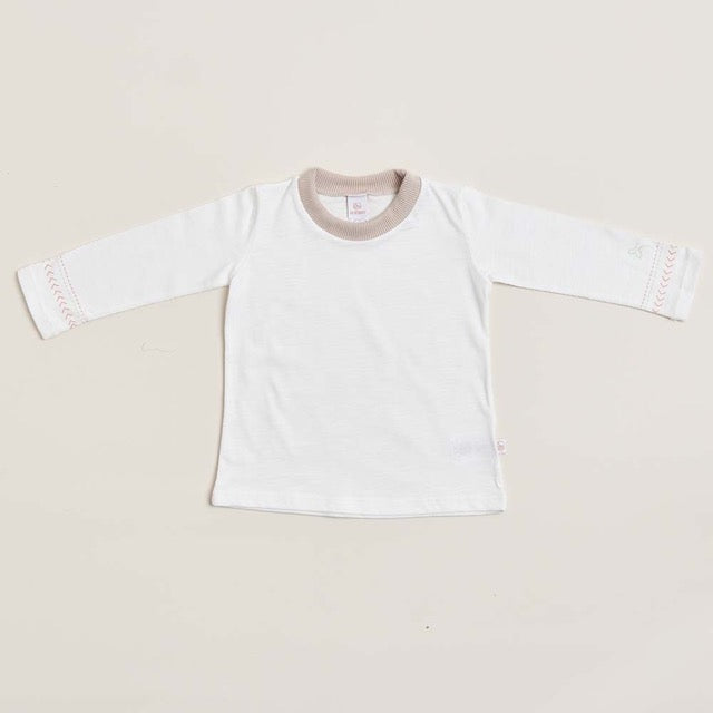A long sleeve white baby shirt with beige pink detailing on the collar and cuffs, displayed against a neutral background.