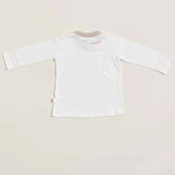 The back of a long sleeve white baby shirt with beige pink detailing on the collar and cuffs, displayed against a neutral background.