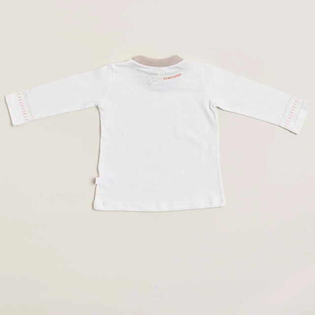 The back of a long sleeve white baby shirt with beige pink detailing on the collar and cuffs, displayed against a neutral background.