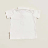 The back of a white soft cotton polo shirt with a faux pocket, standing against a white background.