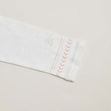 Close-up of arrows and line details on a kids long sleeve shirt.