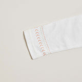 Close-up of arrows and line details on a kids long sleeve shirt.