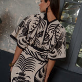 Woman wearing a white and black patterned kimono.