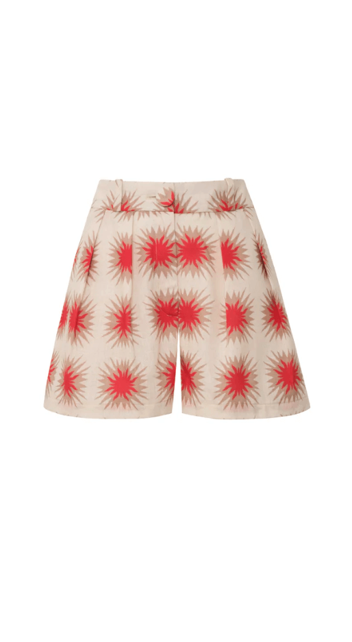 A model wearing Encantadore's Fede Red Star Shorts, which are knee-length with a wide-leg fit and a red star pattern.