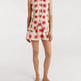 A model wearing Encantadore's Fede Red Star Shorts, which are knee-length with a wide-leg fit and a red star pattern.