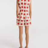 A model wearing Encantadore's Fede Red Star Shorts, which are knee-length with a wide-leg fit and a red star pattern.
