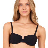 A woman wearing a black underwire bikini top.