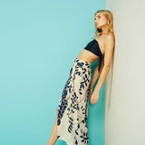 Black and white pareo skirt with a giraffe and leafs on it.