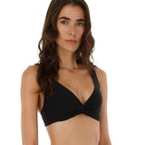 Woman wearing a black bikini top on a white background.