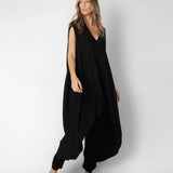 Image of woman wearing a flowy jumpsuit against a white background. The purpose of this image is to highlight the jumpsuit from NAOS, which is for sale at EVAMAIA boutique in Studio City, CA.