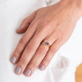 Close up image of a woman wearing 3 dainty gold rings with a raw stones on them. The purpose of this image is to highlight the jewelry because it is for sale at EVAMAIA boutique in Studio City, CA and online.