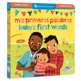 Board book cover of 'Mis primeras palabras - Baby's First Words' featuring illustrations of a family with two dads, a baby, and various colorful objects.