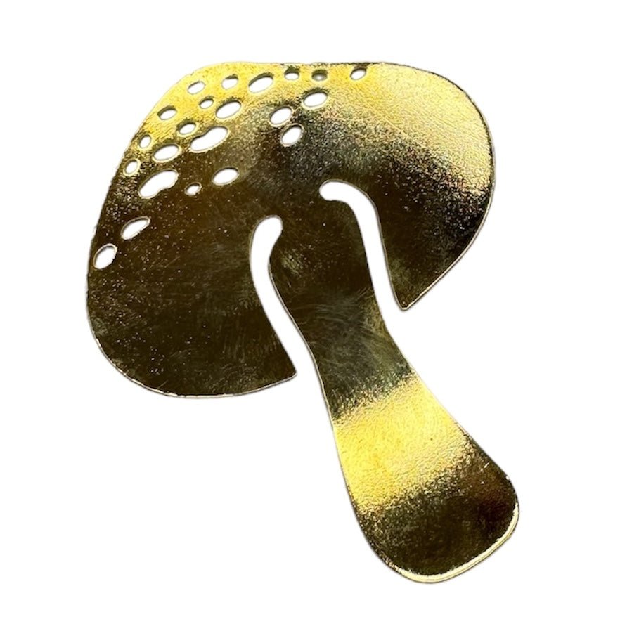 Close up image of a mushroom-shaped bookmark in gold. The purpose of this image is to highlight the bookmark, which is handmade by PAJAROLIMON.