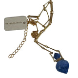 Image of a gold necklace holding a sodalite stone perfume bottle. The purpose of this image is to highlight the necklace. This necklace is made in Colombia by Pajarolimon and sold at EVAMAIA boutique.