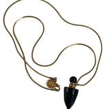 Image of a gold necklace holding a black obsidian perfume bottle. The purpose of this image is to highlight the necklace. This necklace is made in Colombia by Pajarolimon and sold at EVAMAIA boutique.