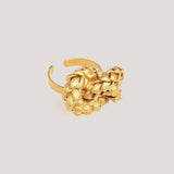 Image of a gold ring with a knot design. The purpose of this image is to highlight the ring by Alma Jewelry.
