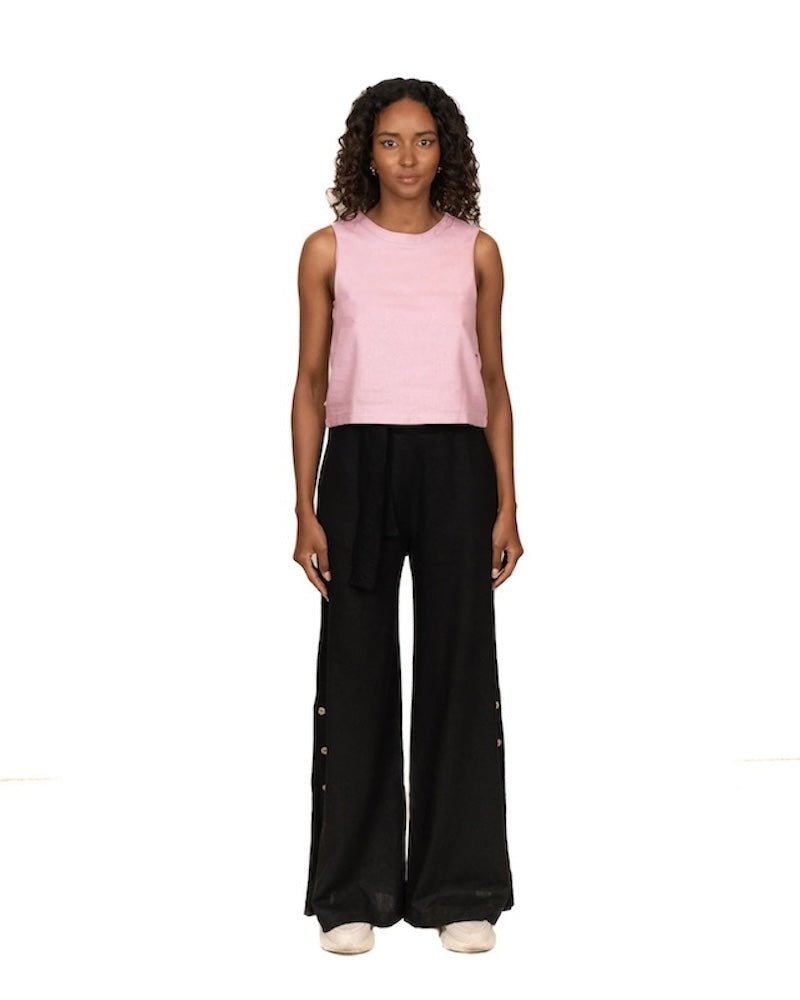 Woman wearing a linen top and pants. She's standing behind a white background. The purpose of this image is to highlight the clothing, which is made in Colombia and sold at EVAMAIA Boutique in Studio City, CA.