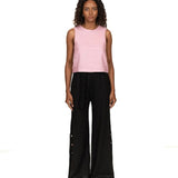Woman wearing a linen top and pants. She's standing behind a white background. The purpose of this image is to highlight the clothing, which is made in Colombia and sold at EVAMAIA Boutique in Studio City, CA.