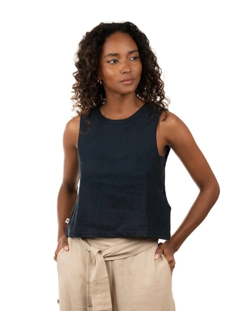 Woman wearing a linen top and pants. She's standing behind a white background. The purpose of this image is to highlight the clothing, which is made in Colombia and sold at EVAMAIA Boutique in Studio City, CA.