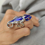 Woman modeling blue chameleon ring
