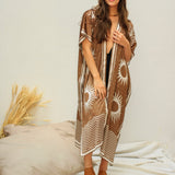 She is looking at us wearing the brown golden suns kimono. She paired the kimono with brown open back slip ons.