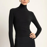 A long sleeve turtle neck styled with biker shorts.