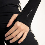 A close up of a turtle neck with holes for thumbs in the sleeves.